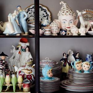 Порцеланови композиции от порцеланови чаши, фигурки и малки вази на рафтове